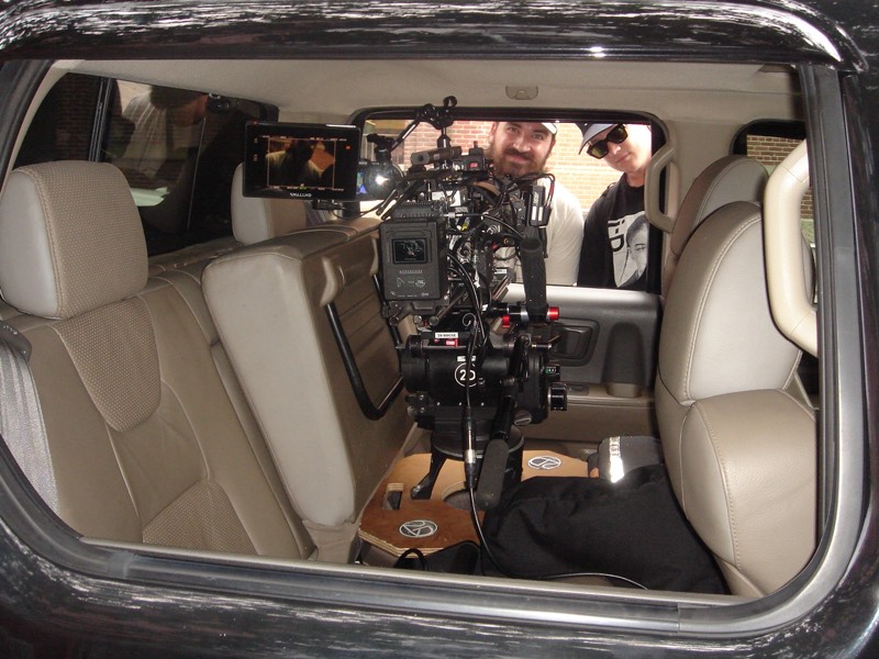 Cinema camera rig set up inside a vehicle interior