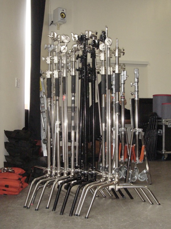 A cluster of C-stands lined up together indoors