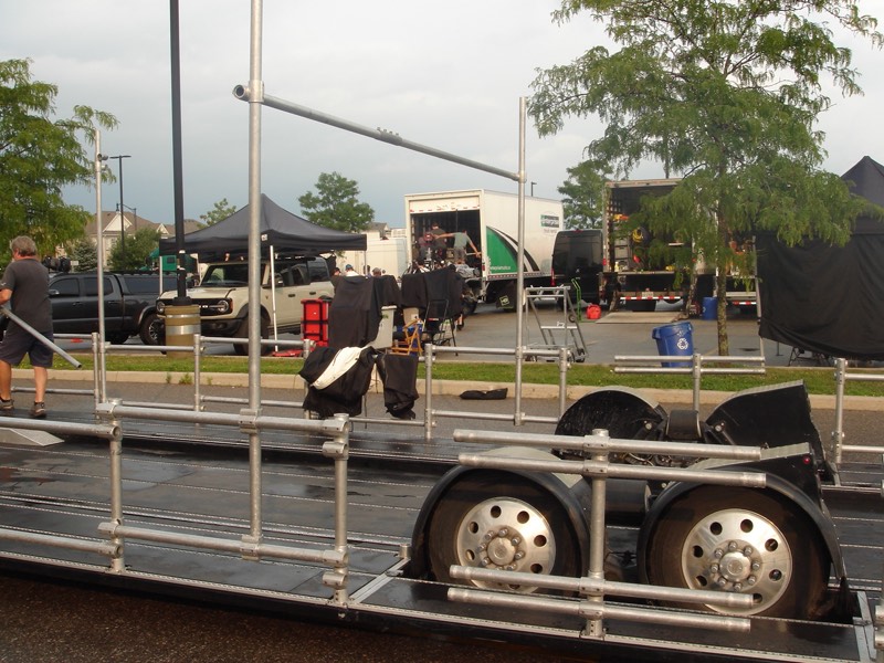 Production trailer and set vehicles staged in a parking lot
