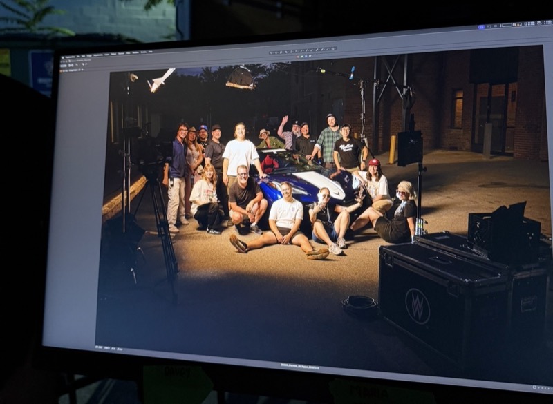 Monitor showing a group photo of the crew on the finished set